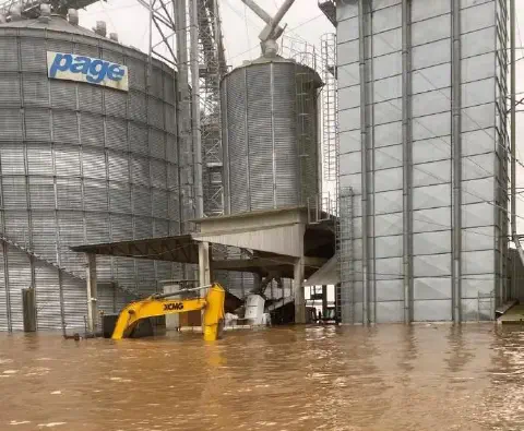 cenário de desastre em uma instalação de armazenamento de grãos, severamente afetada por uma inundação. G
