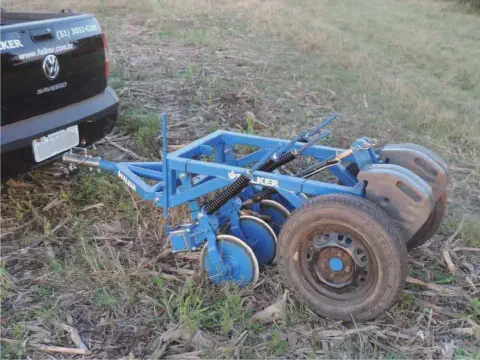implemento agrícola de cor azul, especificamente uma plantadeira ou semeadora da marca Falker, em um ambien
