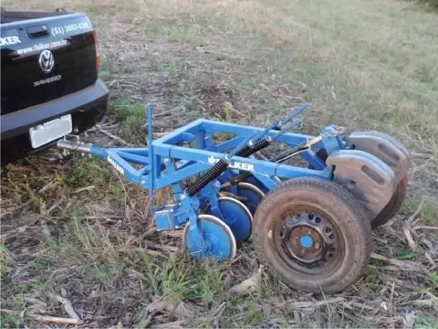 implemento agrícola de cor azul, especificamente uma plantadeira ou semeadora da marca Falker, em um ambien