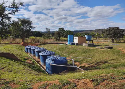 instalação de infraestrutura hídrica em uma propriedade rural. Em primeiro plano, vemos um sistema compo