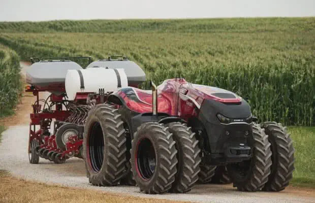 Trator Autônomo: O Futuro da Tecnologia na Agricultura trator autônomo de design futurista, o conceito Case IH Magnum, em uma estrada de terra ao lado de uma vast
